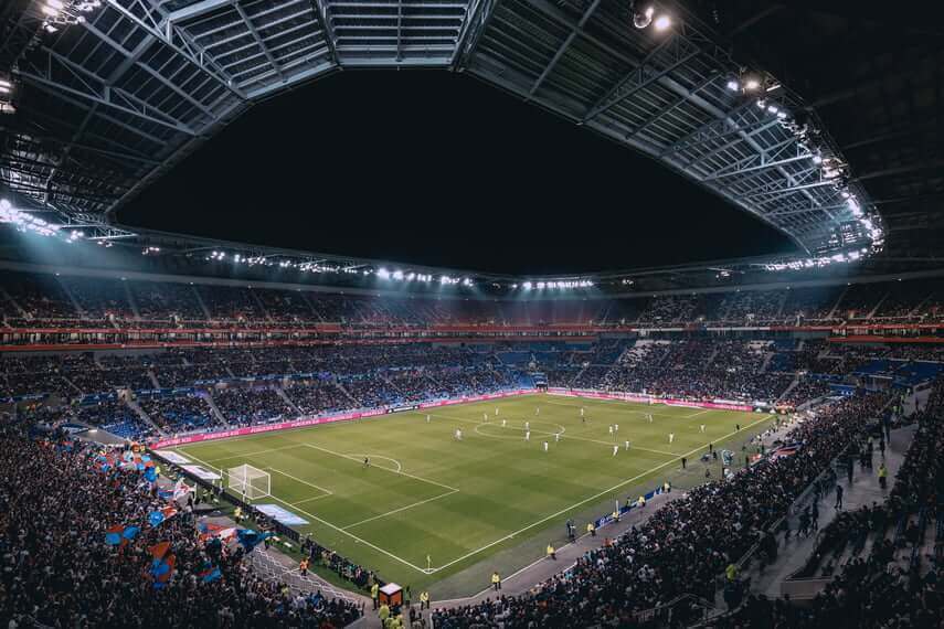 Full view of football stadium in the evening, full with spectators which cause congestion. 