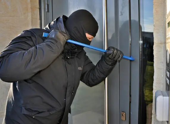 masked burglar with crowbar
